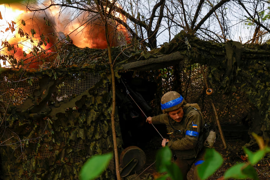 A Ukrainian artillery commander fires toward Russian troops on the Kharkiv front line