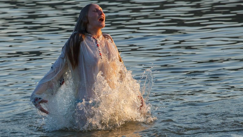 A Ukrainian girl bathes in a river