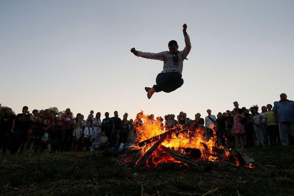 A man jumps over a fire during the Ivana Kupala celebration in Kyiv, Ukraine