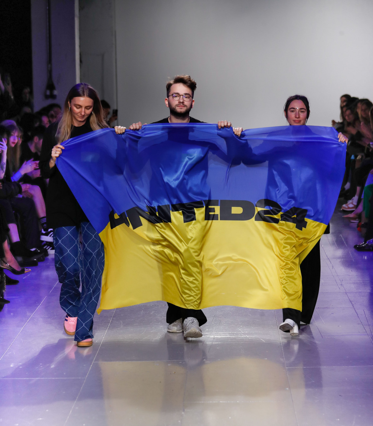 Ukrainian fashion designers. Left to right:  Ksenia Schaider, Ivan Frolov, and Julie Pascal call for support for Ukraine at London Fashion Week.