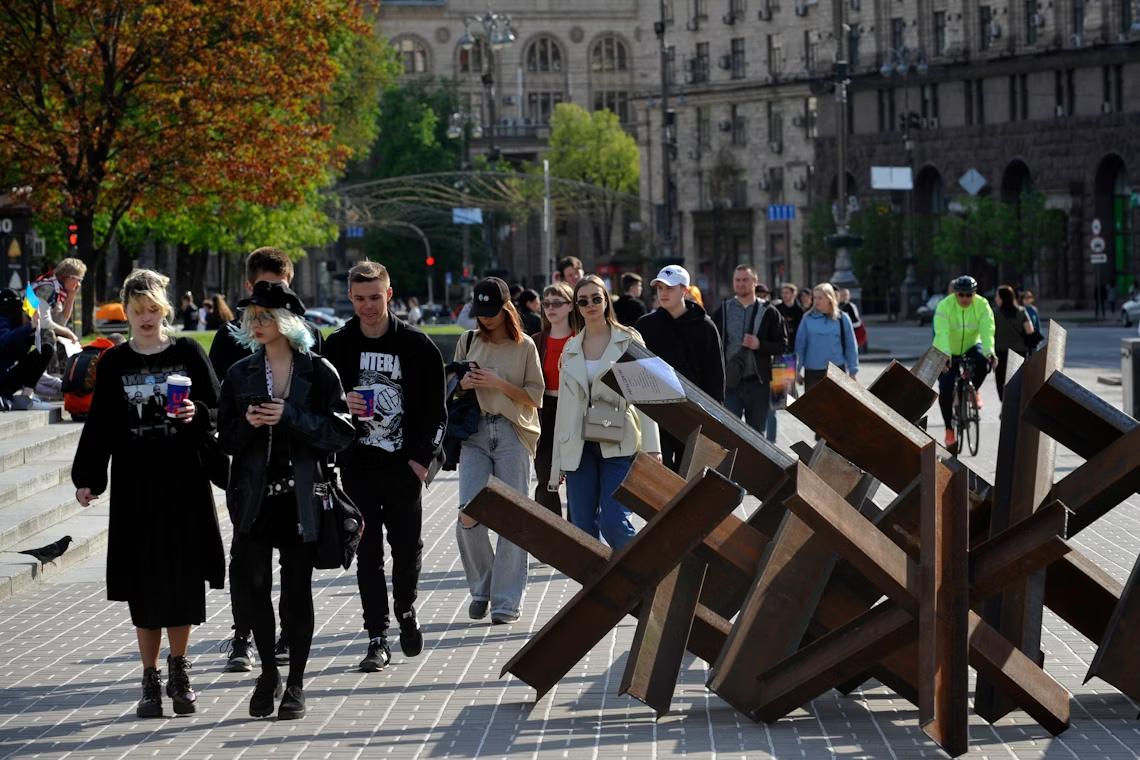 Is it safe to travel to Kyiv: People walk past anti-tank hedgehogs in Independence Square in Kyiv in 2022