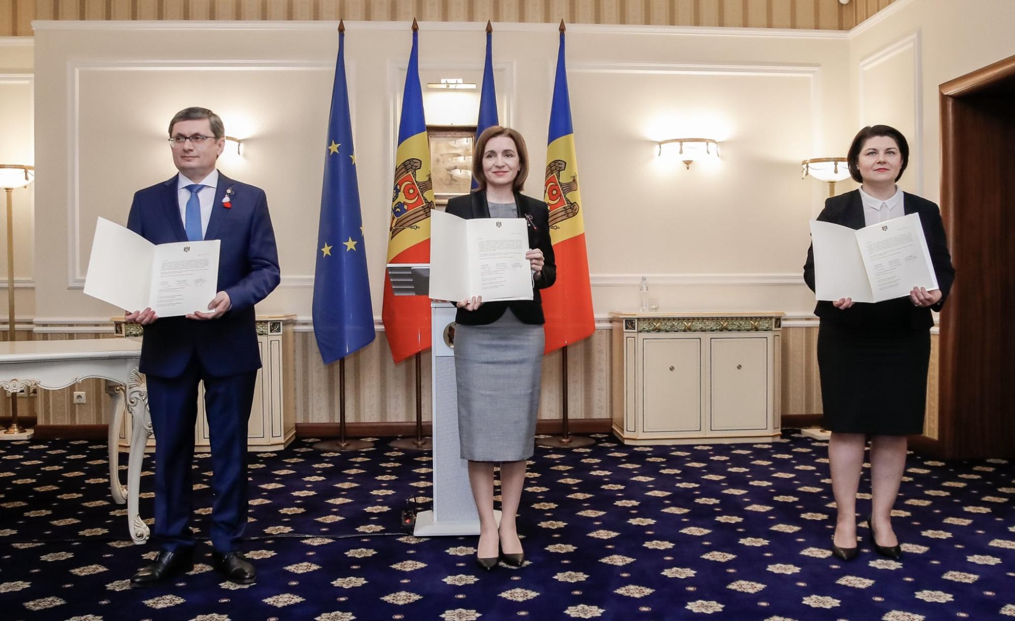 After signing Moldova's application to join the EU, Moldovan President Maia Sandu, center, PM Natalia Gavrilita, right, and Speaker of Parliament Igor Grosu.