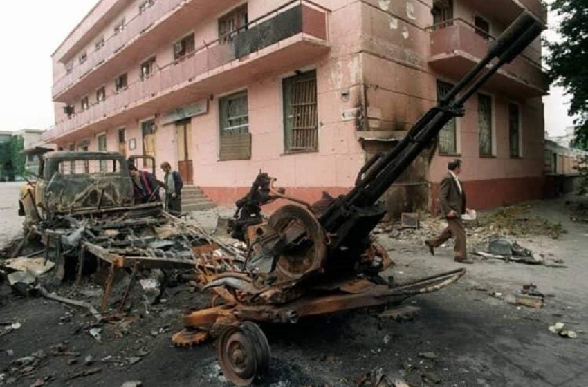 Invaded by Russia: Residents of the Moldovan city of Bendery pass by destroyed military equipment during the fighting in the town in 1992